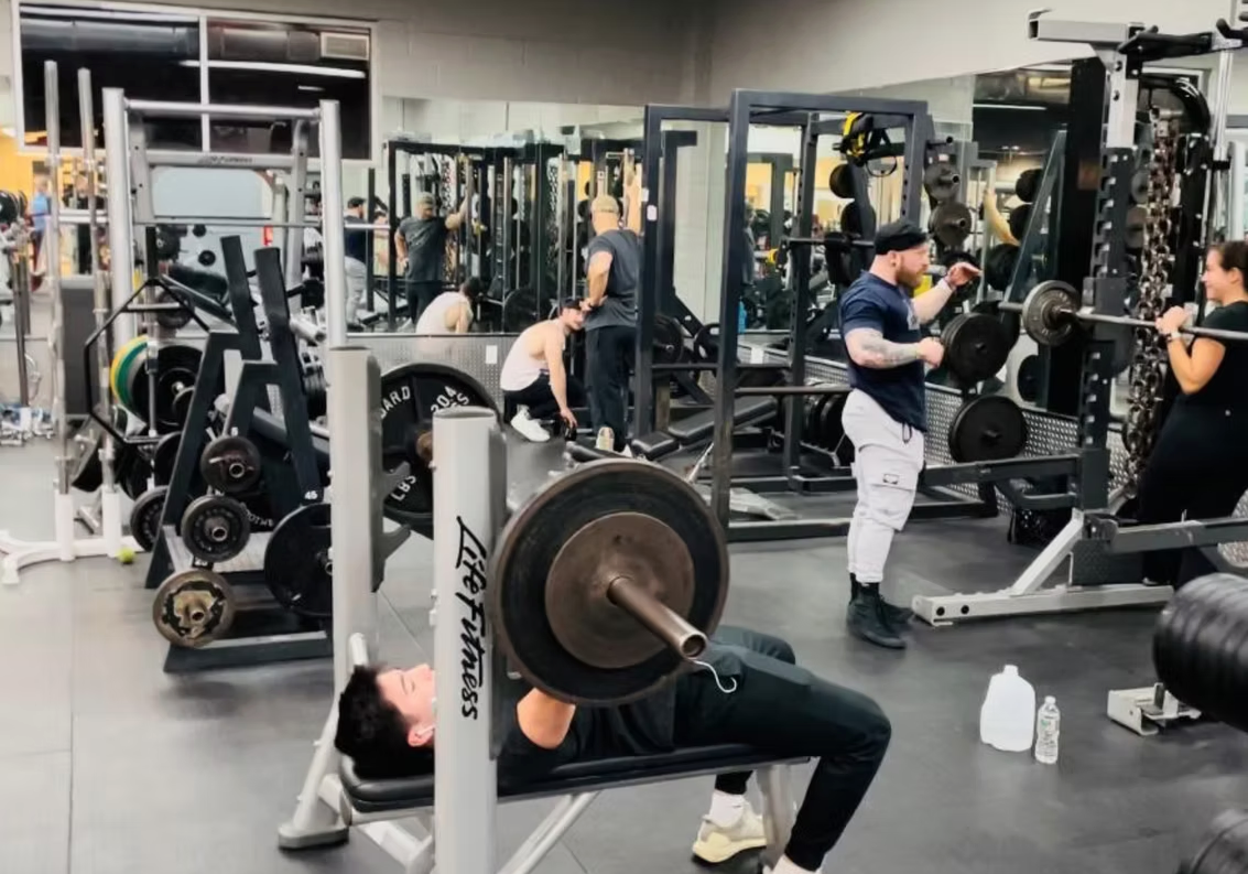 Members training on the bench press and squat racks