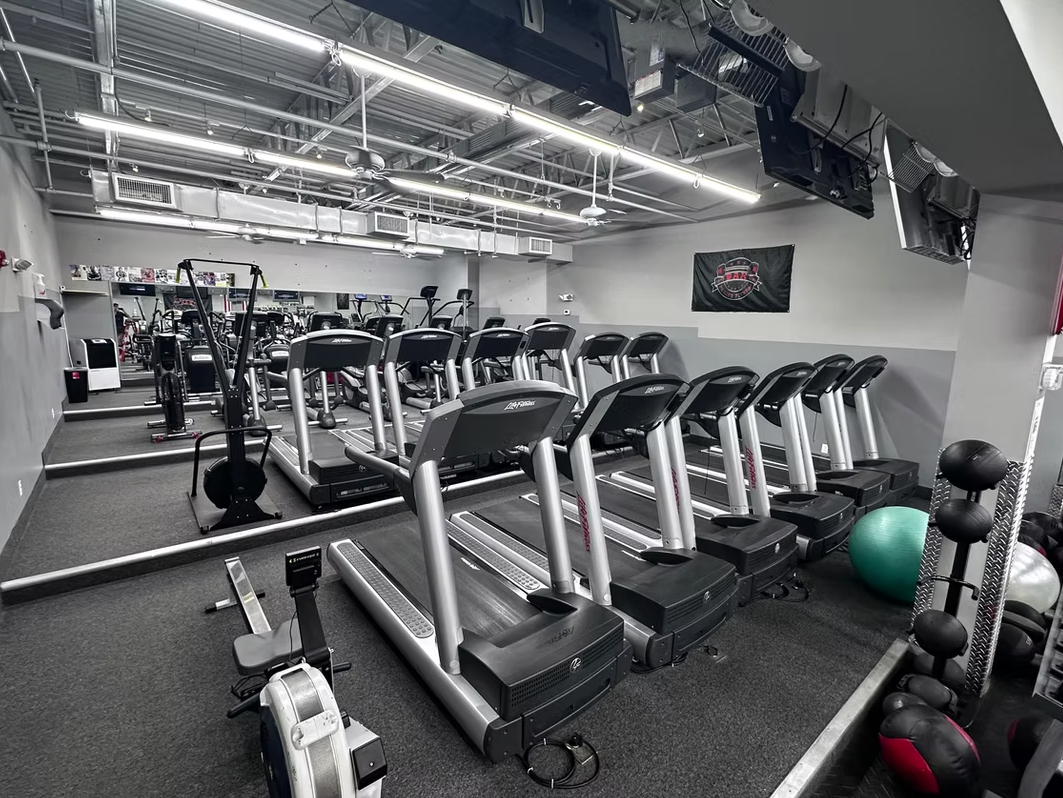 Cardio room with treadmills, ellipticals, and rowers at BAK To Life Fitness
