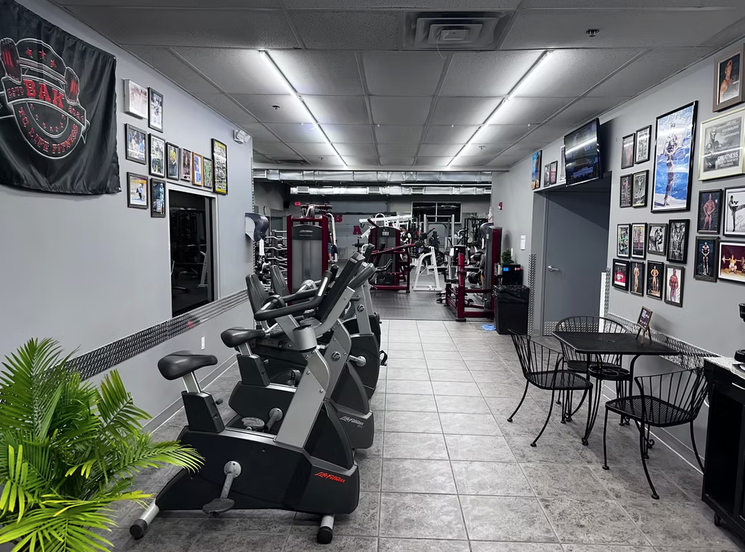 BAK To Life Fitness lobby with cardio bikes and trophy wall